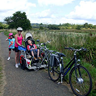 A family using a custom made wheelchair bike trailer with their son