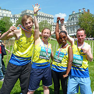 Four fundraisers celebrate finishing a race