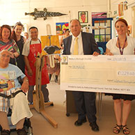 A cheque is presented to fund an accessible easel