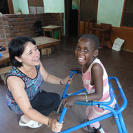 A young girl in Malawi uses a walking frame supplied through our recycling initiative