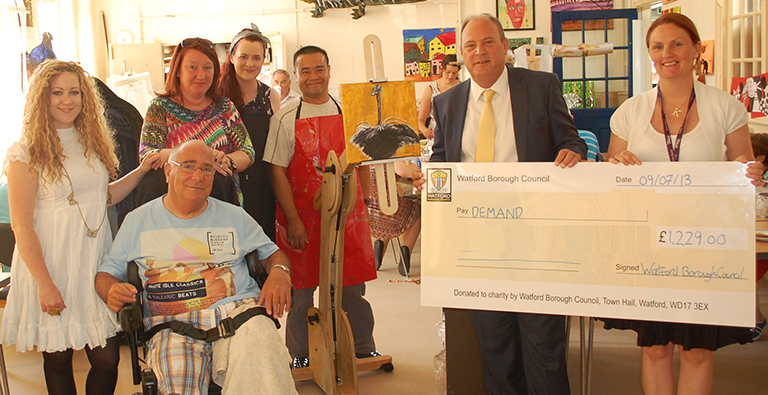 A cheque is presented to fund an accessible easel 