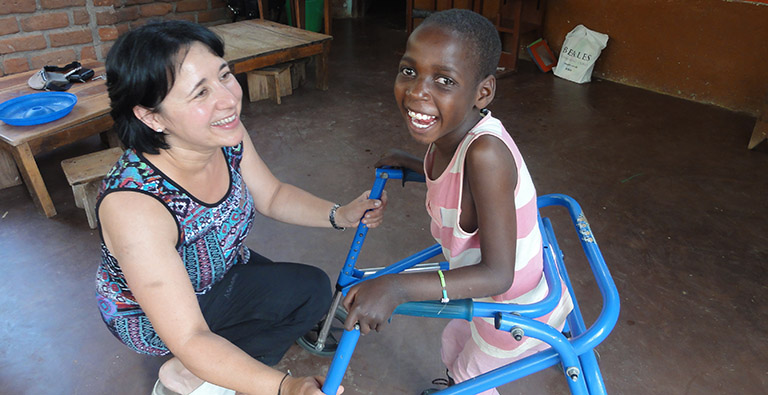 A young girl in Malawi uses a Kaye walker donated through DEMAND's recycling initative