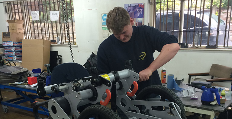 A DEMAND engineer carrying out a service on a Chunc wheelchair